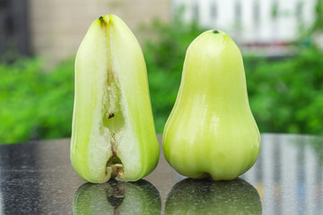 green rose apple on black marble. outdoor. garden. day