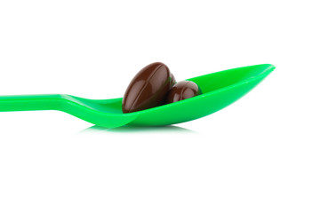 supplementary. vitamin E. eating. green spoon.  isolated on white background