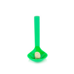green spoon plastic with supplementary garlic  isolated on white background