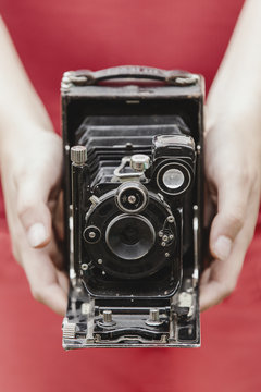 Woman Holding An Old Camera