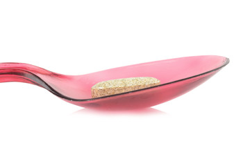 red spoon plastic with supplementary garlic  isolated on white background