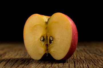 apple on wooden. black background