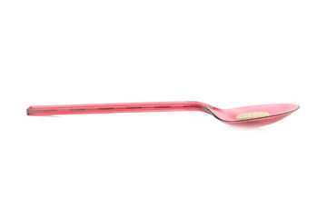 red spoon plastic with supplementary garlic  isolated on white background