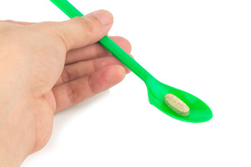 green spoon plastic with supplementary garlic  isolated on white background