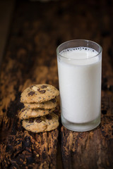 Homemade cookies with milk on wooden table background
