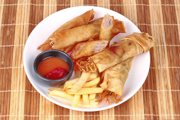 Deep fried spring roll,and frence fries sreved with tomato souce and chili sauce.