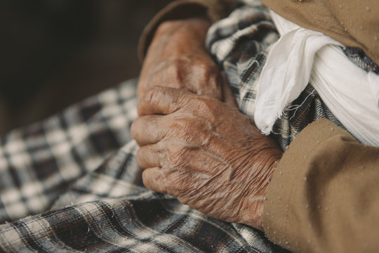 old hands with wrinkles.