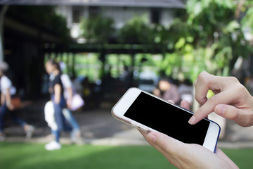 Woman using touch screen mobile phone with Coffee shop blur background