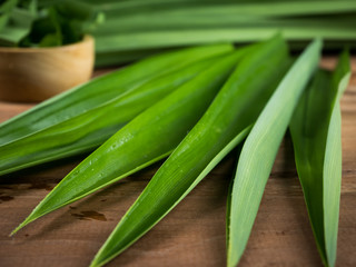 Pandan and pandan leaves in a wooden cup prepared for pandan juice or pandan cake to boil or dried Before going to cooking.