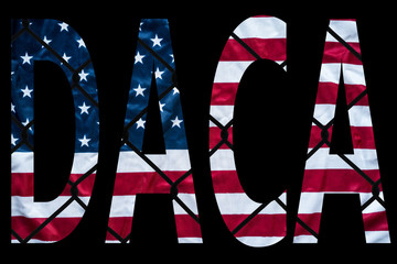 DACA bold letters with american flag and chain link fence in the background - 177863812