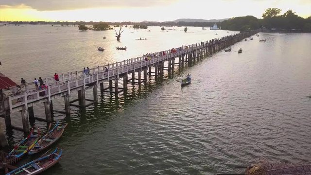 4K aerial view from the drone on the U Bein bridge, crossing that spans the Taungthaman Lake near Amarapura in Myanmar