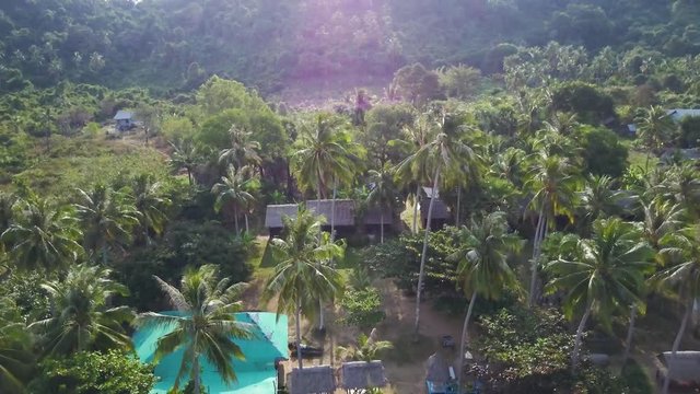 Camera pulling away from a village in paradise.