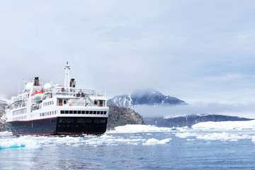 luxury passenger ship sails on icy sea in antarctic in clouds ky