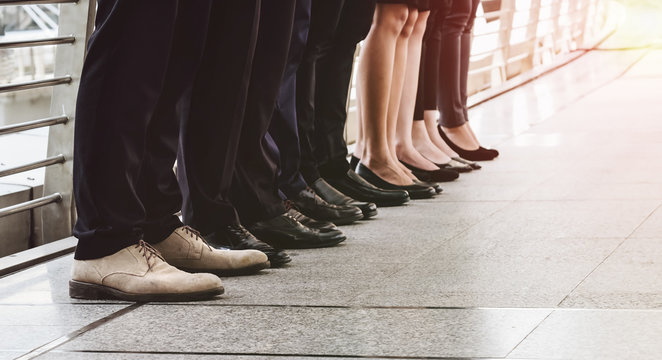 Shoes and legs of businessmen stand together. Successful Business Concepts.