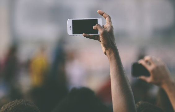 funs shooting music concert on smartphones .
