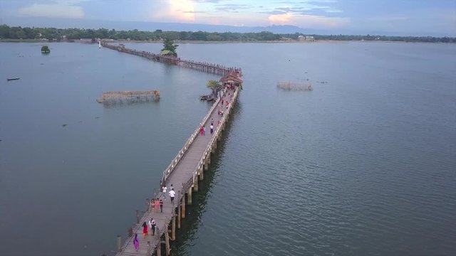 4K aerial view from the drone on the U Bein bridge, crossing that spans the Taungthaman Lake near Amarapura in Myanmar