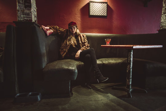 Beautiful Woman drinking alone in a beatnik lounge in San Francisco