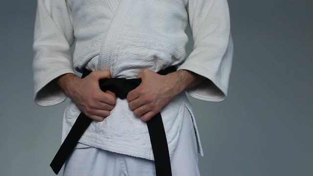 Martial arts Master tightening black belt