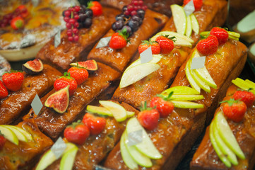 Delicious french cakes with berries and chocolate