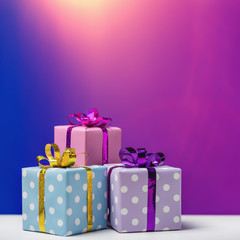Boxes with gifts on festive background.