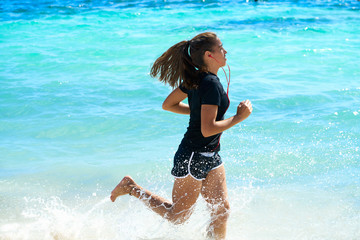 Latin girl running in caribbean shore beach