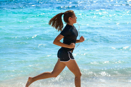 Latin girl running in caribbean shore beach