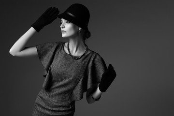 young elegant woman, retro fashion, hat, gloves, dress.