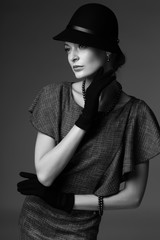 young elegant woman, retro fashion, hat, gloves, dress.