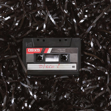 Old audio cassette on a bed of loose tape