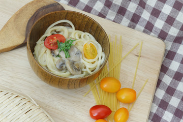 Spaghetti carbonara with white button mushroom and honey tomatoes on the kitchen table
