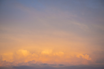 The sky is painted in bright yellow-orange shades.