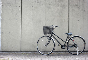 a bicycle white concrete wall as background 