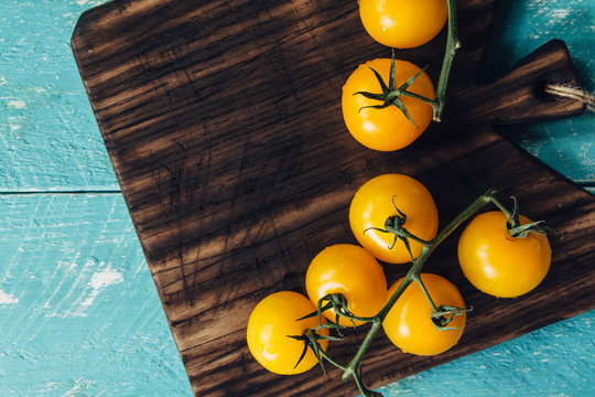 From Above Yellow Tomatoes on a Dark Cutting Board