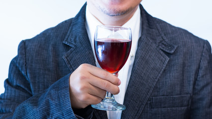 man holding a glass of red wine
