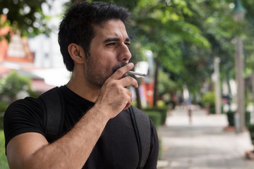 asian man smoker smoking cigarette