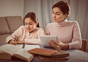 Mother and daughter doing school homework