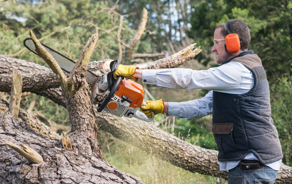 man using chainsaw