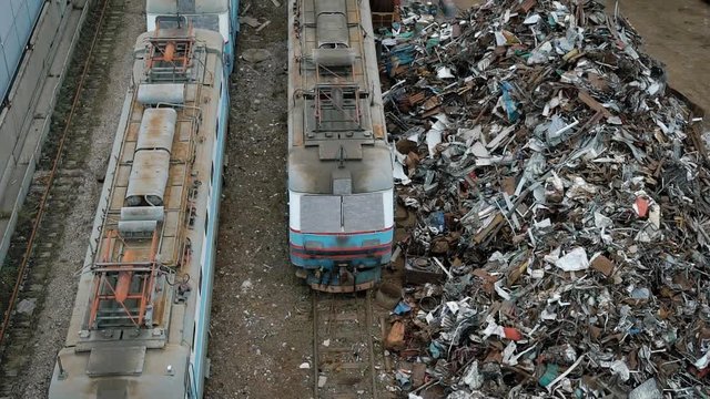 A view from above of old and broken trams, next to them is a non-ferrous metal that will be processed and sent to a new production facility