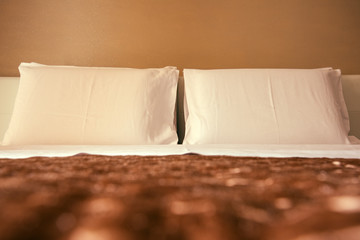 Pillows in hotel bedroom bed