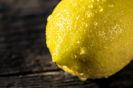 Fresh wet lemon with water drops
