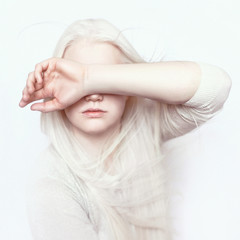 Albino girl with white skin, natural lips and white hair. Photo face on a light background. Portrait of the head. Blonde girl - obrazy, fototapety, plakaty