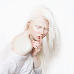 Albino girl with white skin, natural lips and white hair. Photo face on a light background. Portrait of the head. Blonde girl - 177879846