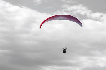Paragliding in the grey sky