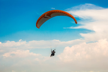 Paragliding in the blue sky