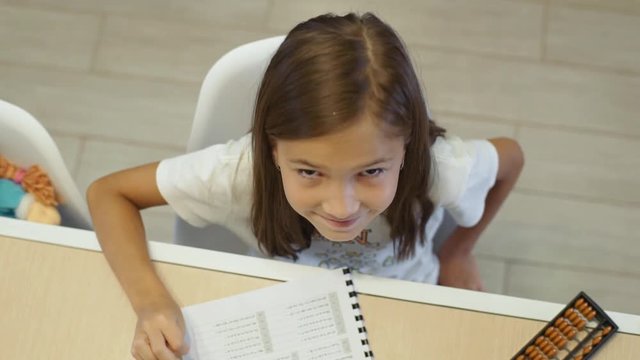 A girl of 8 years of age studies at home on mental arithmetic