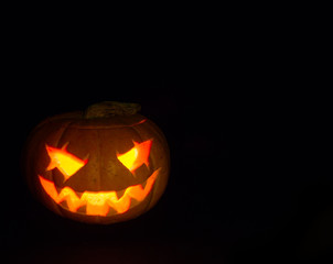 Scary head made of pumpkin. A real fire. Holiday Halloween.
