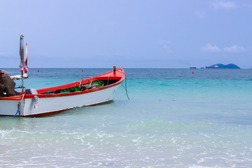 Fototapeta premium Red and white boat parked near the beach. thailand
