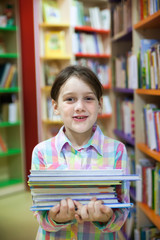 school girl in library choosing books.