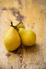 Bio Pears on rustic wooden background. Autumn fruits 