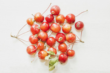 Naklejka na ściany i meble Red ripe apples Malus ‘Ranetka' on white background.